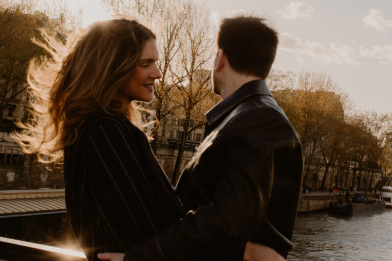 Romantic couple walking along the Seine in Paris